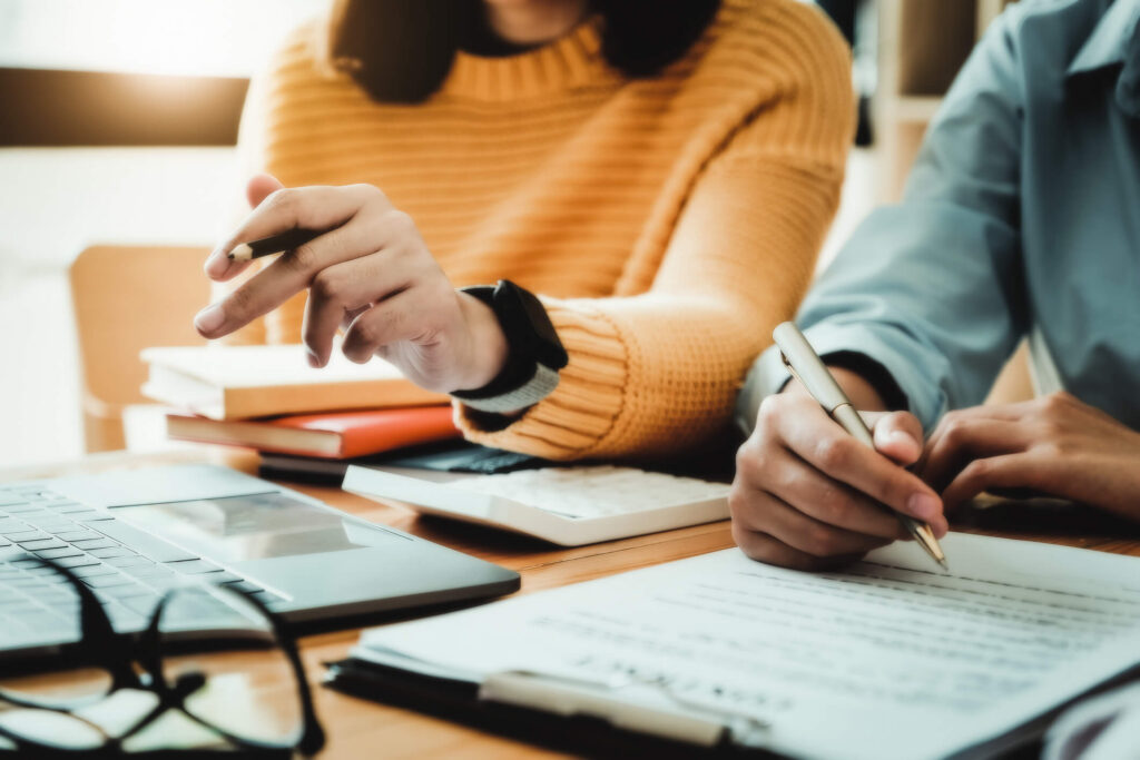 two people looking at documents together